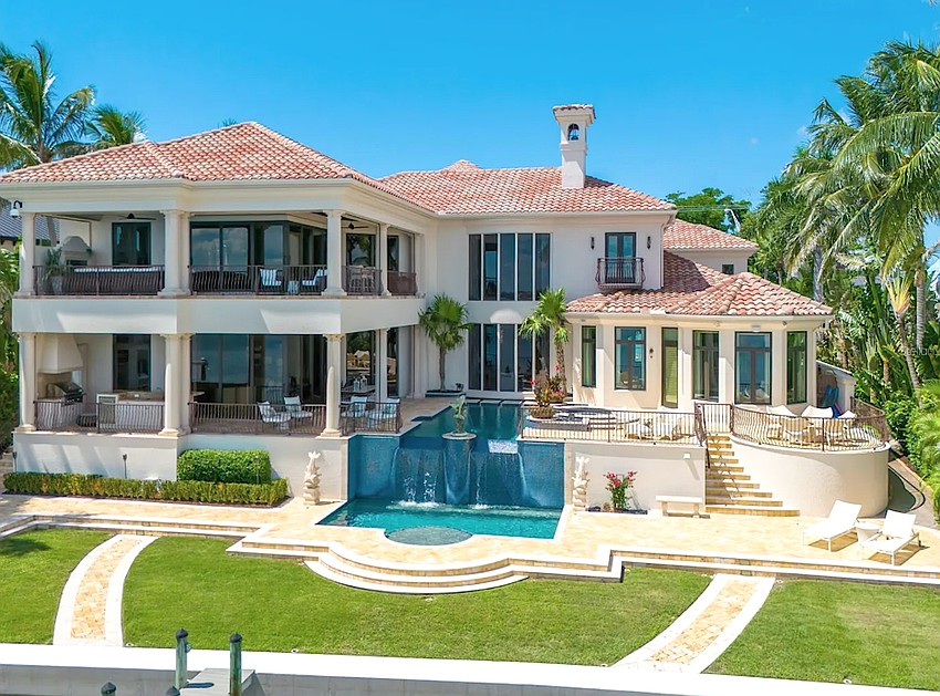 The home at 1436 John Ringling Parkway features a backyard oasis with infinity pool, outdoor kitchen and multiple lounge areas.