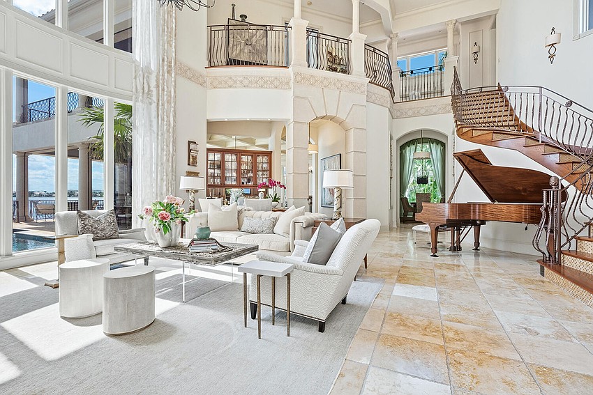 The two-story foyer opens to a great room with walls of windows. The two-story foyer opens to a great room with walls of windows.