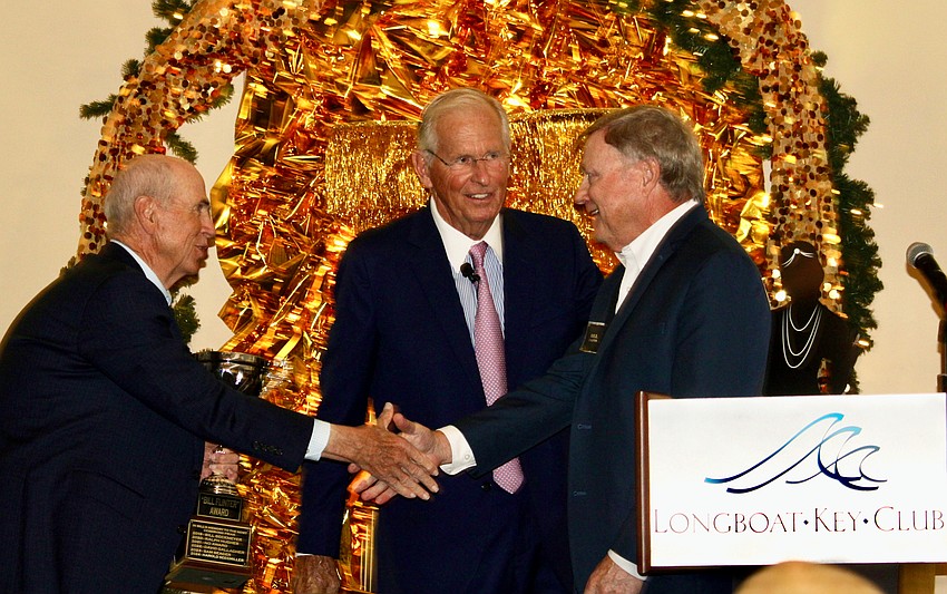 Dave Gallagher, who earlier in the evening won the second annual Frank Sulzman Golf Genius Award, joins Friars Club president Chuck Eldridge in congratulating Bill Caplin for winning the Bill Flinter Award. Club members held their annual end-of-season dinner March 24 at the Harbourside Ballroom.