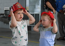 Theo Chien and Peter Ginsburg test out their fire helmets at the Longboat Key Fire Rescue open house on March 25 at Station 92. The pair picked out some fire station-themed toys while meeting first responder staff at the annual event.
