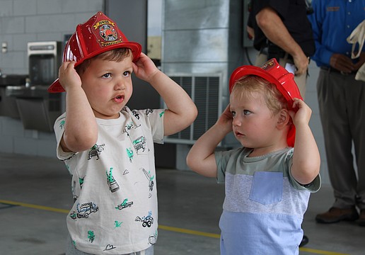 Theo Chien and Peter Ginsburg test out their fire helmets at the Longboat Key Fire Rescue open house on March 25 at Station 92. The pair picked out some fire station-themed toys while meeting first responder staff at the annual event.