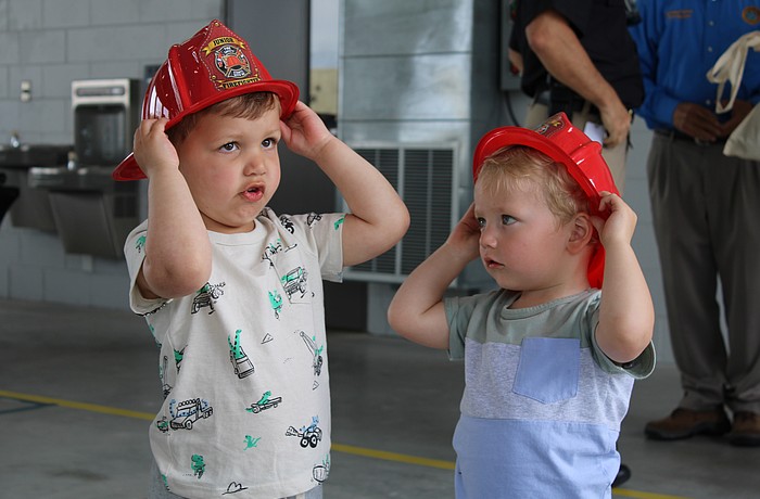 Theo Chien and Peter Ginsburg test out their fire helmets at the Longboat Key Fire Rescue open house on March 25 at Station 92. The pair picked out some fire station-themed toys while meeting first responder staff at the annual event.