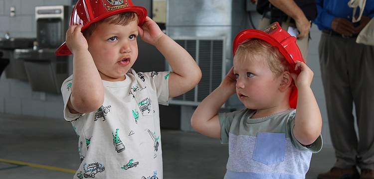 Theo Chien and Peter Ginsburg test out their fire helmets at the Longboat Key Fire Rescue open house on March 25 at Station 92. The pair picked out some fire station-themed toys while meeting first responder staff at the annual event.