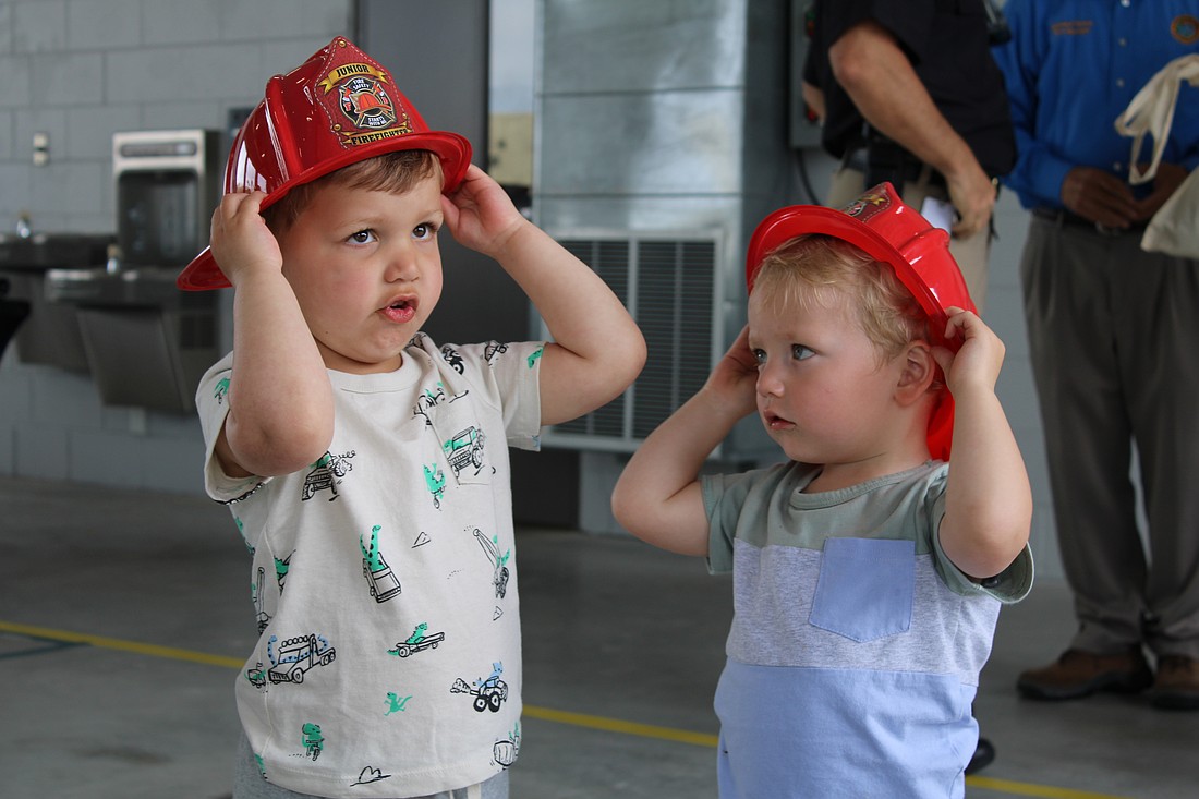 Theo Chien and Peter Ginsburg test out their fire helmets at the Longboat Key Fire Rescue open house on March 25 at Station 92. The pair picked out some fire station-themed toys while meeting first responder staff at the annual event.