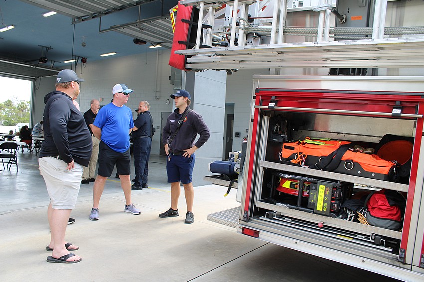David Oliger, a firefighter and paramedic with the Longboat Key Fire Rescue Department, explains the features of one of the station's fire trucks at an open house.