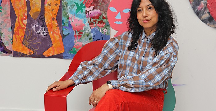 Artist Maria A. Guzmán Capron beside one of her large-scale textile works featured in “Maria A. Guzmán Capron: Penumbra,” on view at Sarasota Art Museum through Sept. 27.