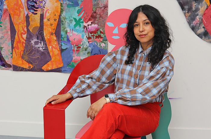 Artist Maria A. Guzmán Capron beside one of her large-scale textile works featured in “Maria A. Guzmán Capron: Penumbra,” on view at Sarasota Art Museum through Sept. 27.