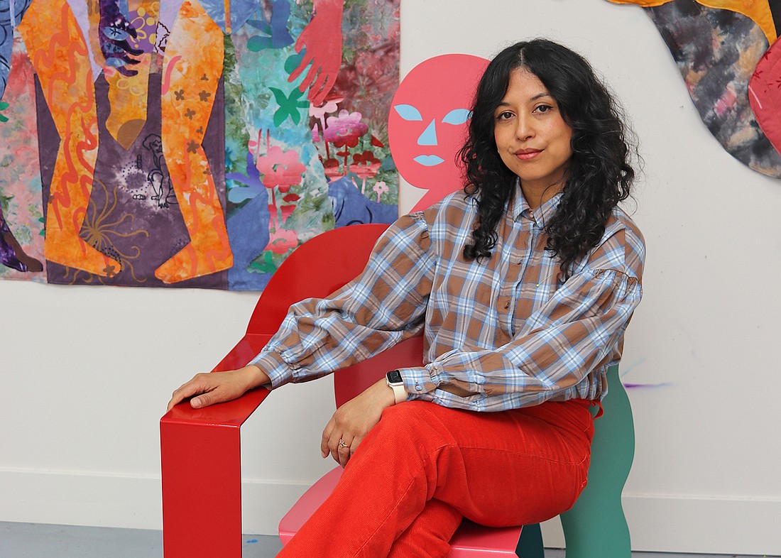 Artist Maria A. Guzmán Capron beside one of her large-scale textile works featured in “Maria A. Guzmán Capron: Penumbra,” on view at Sarasota Art Museum through Sept. 27.