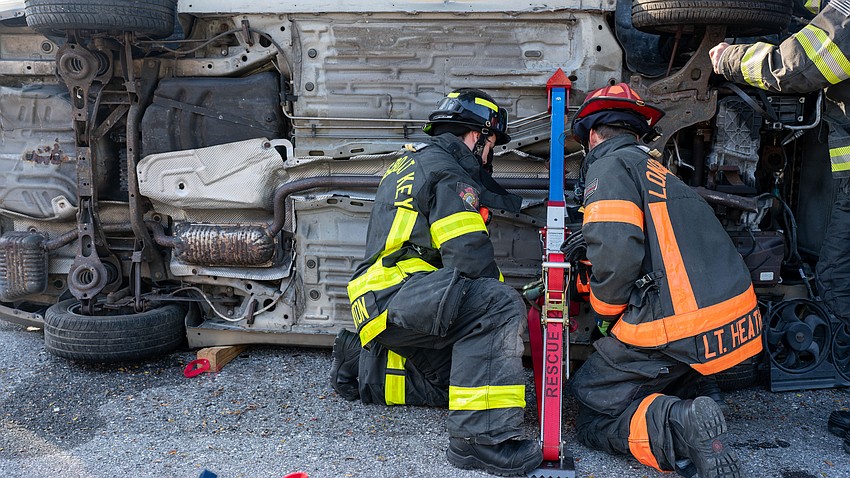 Longboat Key Firefighter Paramedic Tyler Brunton and Lt. Daniel Heath place a strut on the bottom of an overturned vehicle during an extrication training session Thursday, March 26 at Longboat Key Fire Station 91.