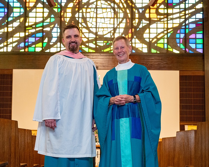 Steven Ball with Rev. Nikki Seger, framed by the church’s vibrant stained-glass windows that depict the story of creation. Steven Ball with Rev. Nikki Seger, framed by the church’s vibrant stained-glass windows that depict the story of creation.