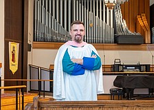 Steven Ball in front of the organ at St. Boniface Episcopal Church, where he directs organ and choral music for the parish’s principal services.