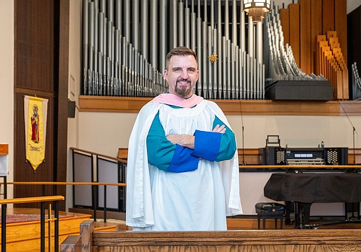 Steven Ball in front of the organ at St. Boniface Episcopal Church, where he directs organ and choral music for the parish’s principal services.