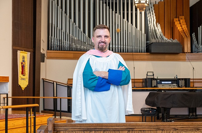 Steven Ball in front of the organ at St. Boniface Episcopal Church, where he directs organ and choral music for the parish’s principal services.