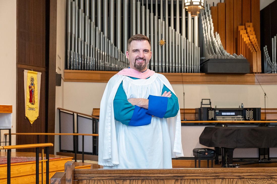 Steven Ball in front of the organ at St. Boniface Episcopal Church, where he directs organ and choral music for the parish’s principal services.