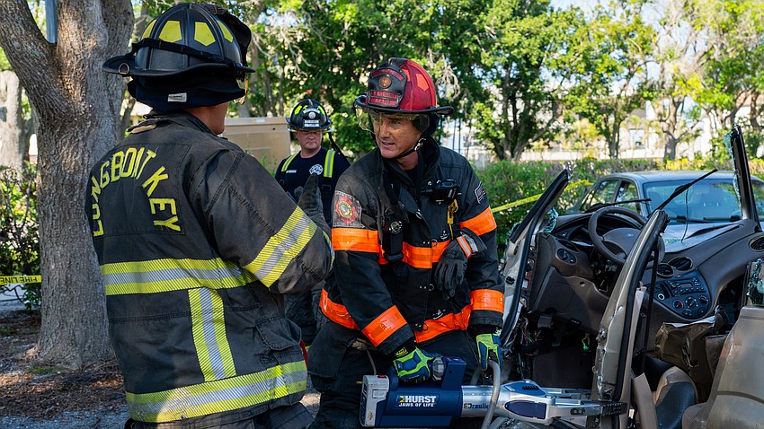 Longboat Key Firefighter Paramedic Josh Falcon (left) and Lt. Daniel Heath (right) work to cut a support beam of an overturned Ford Focus during an extrication training exercise Thursday, March 26 at Longboat Key Fire Station 91.
