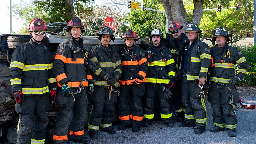 From left to right: Training Captain David Eggleston, Lt. Daniel Heath, Josh Falcon, Lt. Jose Rivera, Tyler Brunton, Lt. Tim Haas, Derek Flaim and Brian Kolesa performed an extrication exercise outside of Fire Station 91 Thursday, March 26.