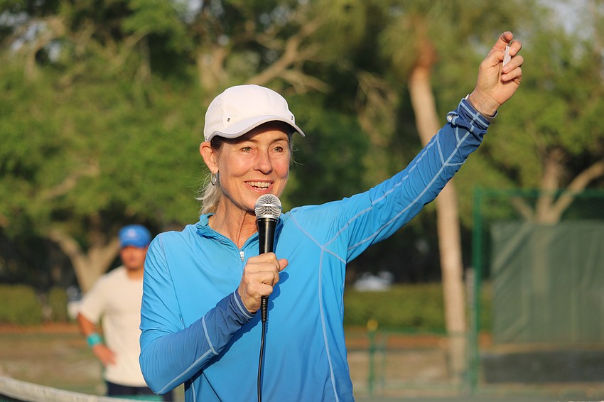Longboat Key Tennis Center manager Kay Thayer pulls the name of the raffle winner for who would get a tennis lesson from her. Tennis players celebrated the end of the season on March 25 on the courts.