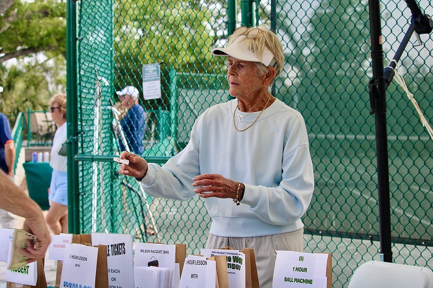 Arden Allen manages the raffle table at the Longboat Key Tennis Center end-of-season party.