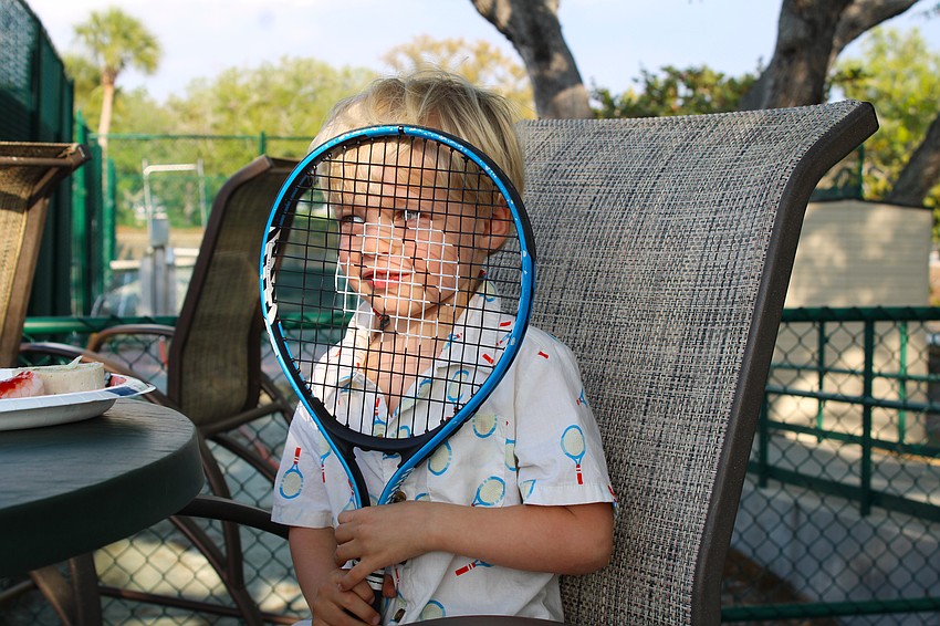 Thomas Herke, wearing an on-theme tennis racket shirt, enjoys the end-of-season party on March 25 at the Longboat Key Tennis Center with friends and family.