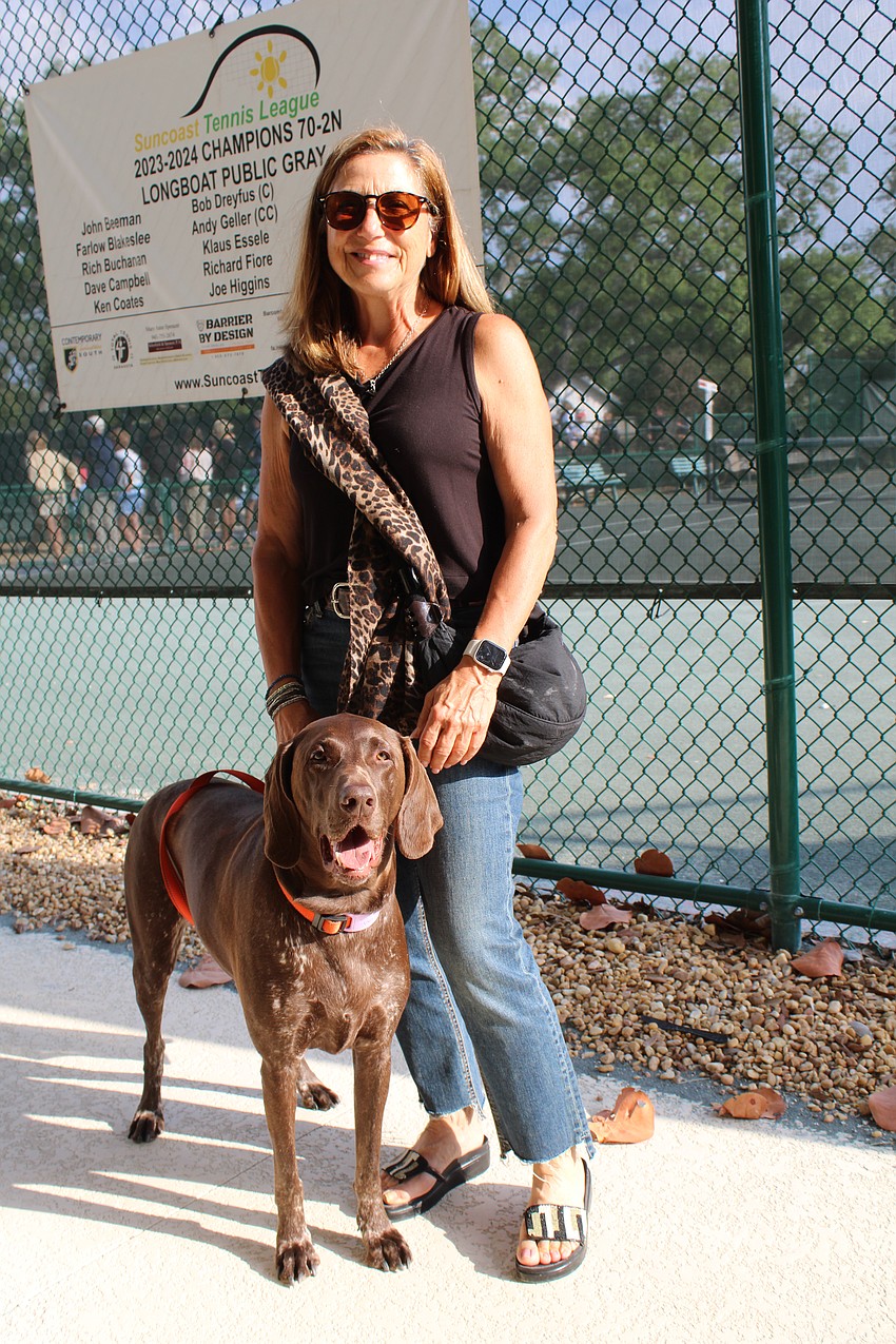 Joey Assaly and her dog, Zuka, check out the action at the Longboat Key Tennis Center end-of-season party.