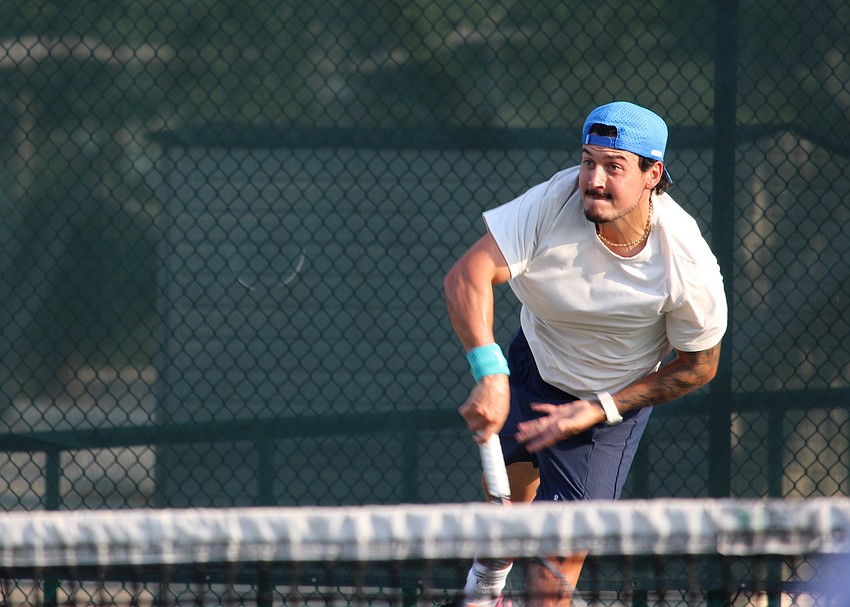 Jhonathan Gonzalez follows through on his serve.