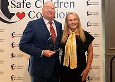 Drayton Saunders acceps a Champion For Children award for MSC Foundation and President and CEO of Safe Children Coalition Brena Slater