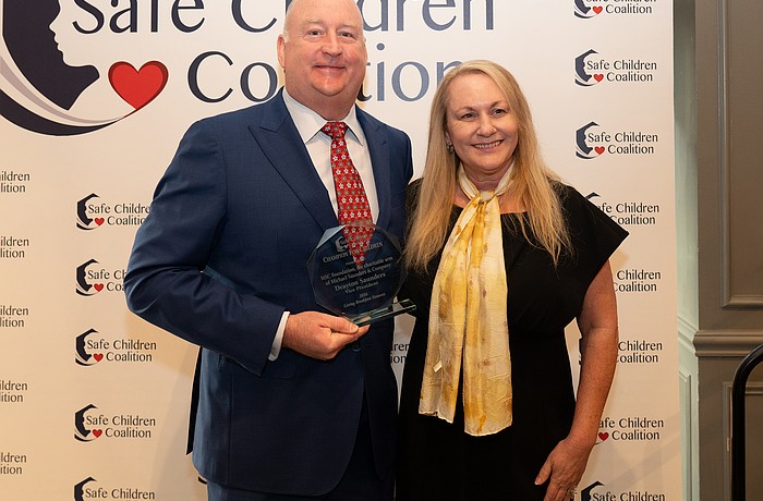 Drayton Saunders acceps a Champion For Children award for MSC Foundation and President and CEO of Safe Children Coalition Brena Slater
