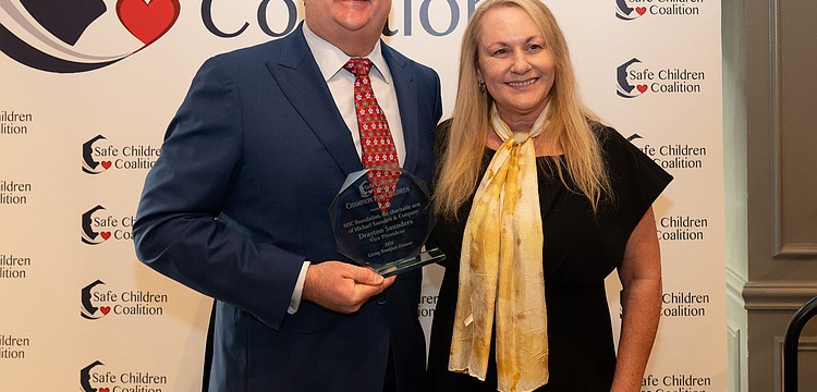 Drayton Saunders acceps a Champion For Children award for MSC Foundation and President and CEO of Safe Children Coalition Brena Slater