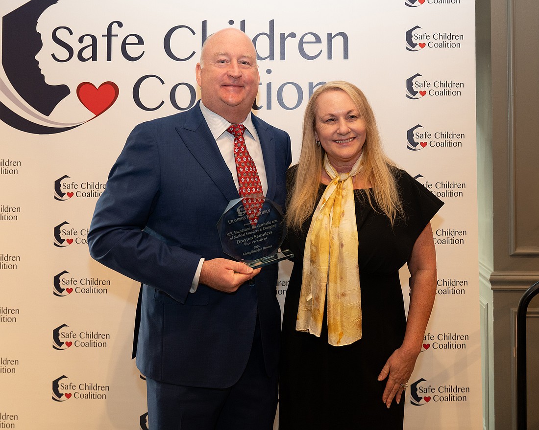 Drayton Saunders acceps a Champion For Children award for MSC Foundation and President and CEO of Safe Children Coalition Brena Slater