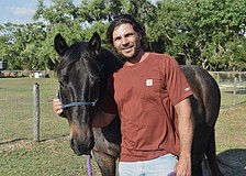 Nate Gold stands with his horse Alonzo.