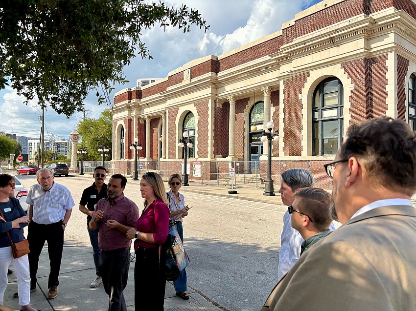 A tour led by the Tampa Bay Community Design Center gathers outside Tampa Union Station.
