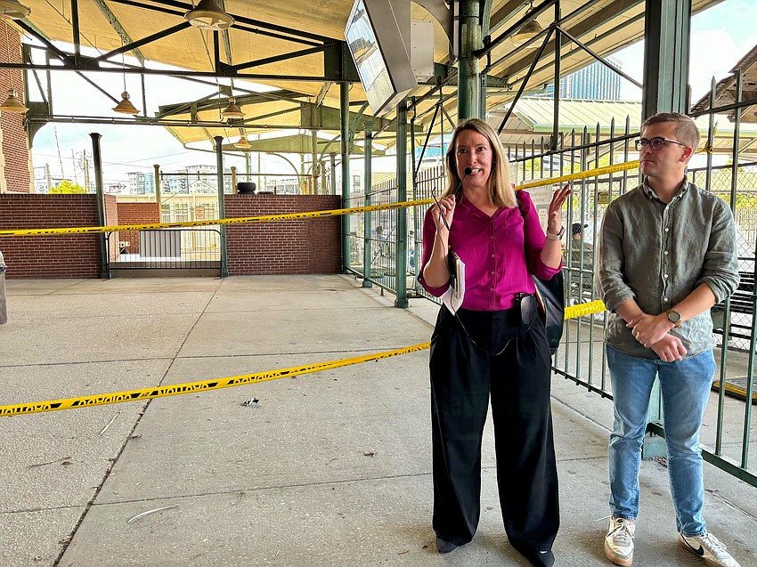 Brandie Mikklus, president of Friends of Tampa Union Station, and member Robert Modys address a tour group near the building’s outdoor terminals.