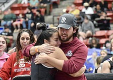 Braden River High girls weightlifting coach Jordan Borges (right) shares a hug with senior Payton Mangay-Ayam (left). Borges said he has seen multiple Florida high school coaches leave their positions because of financial strain.