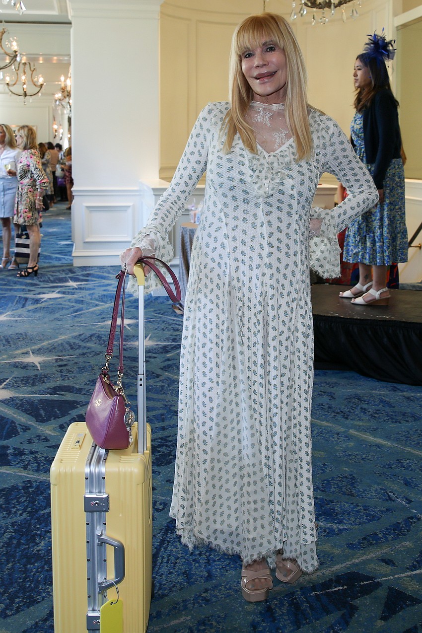 Model Victoria Kasdan wheels her suitcase into the dressing room.