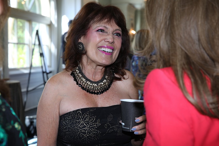 Melba Ramirez catches up with friends.