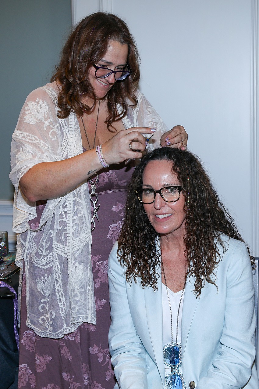 Erin Sleezer enhances the coif of Alisa Craton with some fairy hair.