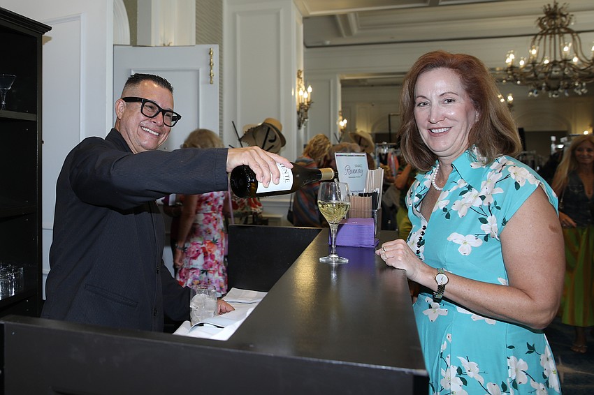 The always smiling Wilmer Triana pours wine for Rosemary McDermott.