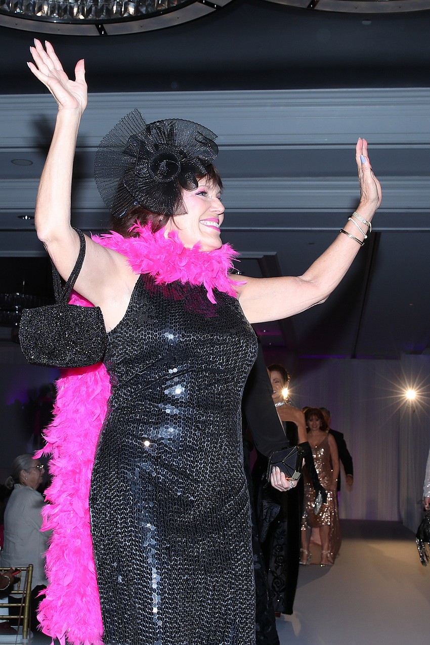 Melba Ramirez's rocks a wildly pink boa.