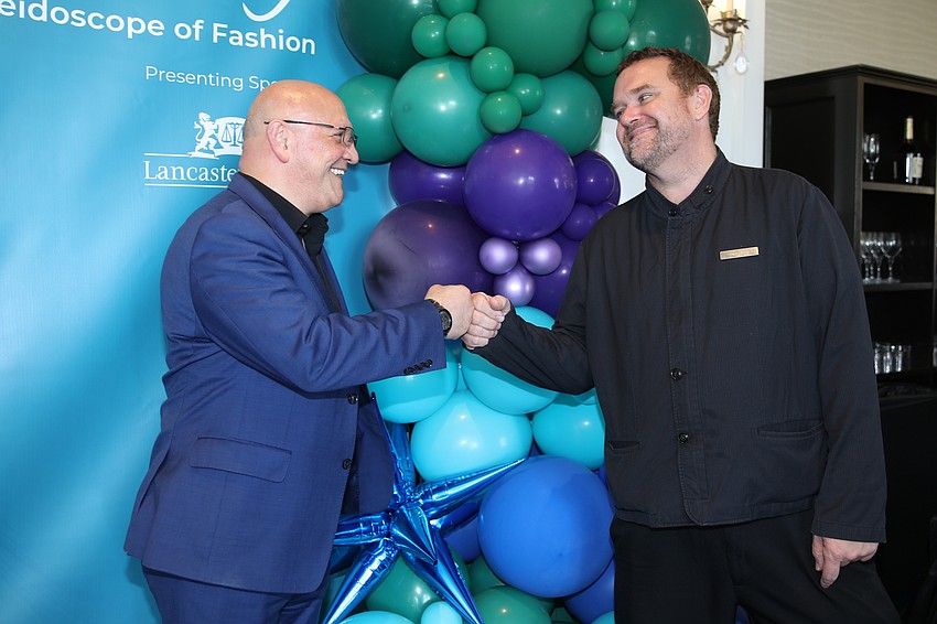 Director of Event Operations Fabian Matute and bartender Andrew Smith fist bump to the successful event.