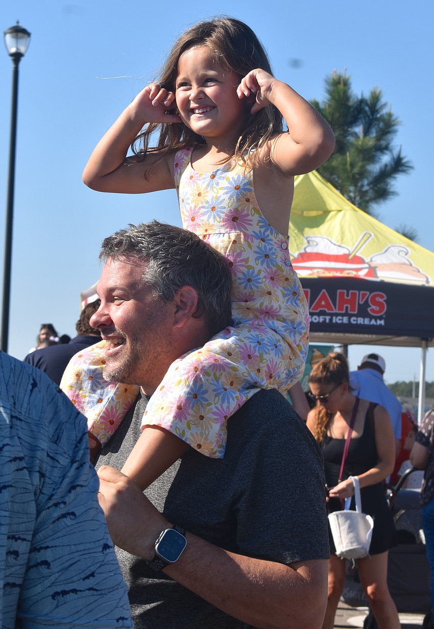 Lakewood Ranch's Whitney Hebl, 5, feels on top of the world on Ryan Hebl's shoulders at Eggstravaganza on March 28.