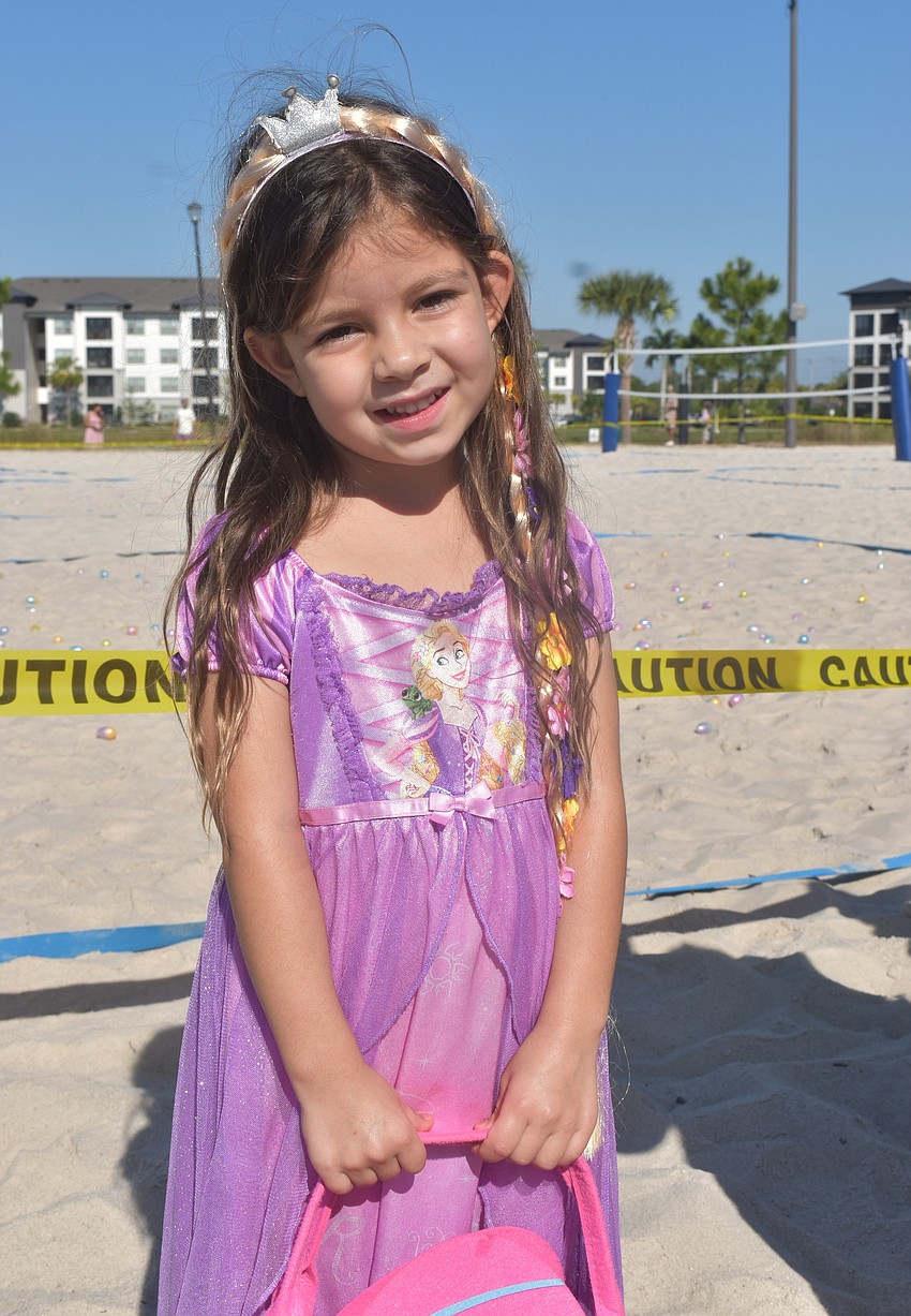 Bradenton's Rox Trapecar, 4, waits patiently for the egg hunt to begin dressed as Rapunzel from 