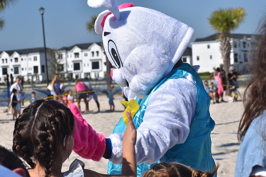 The guest of honor, the Easter Bunny, makes his way around to guests of Eggstravaganza before the egg hunt begins.