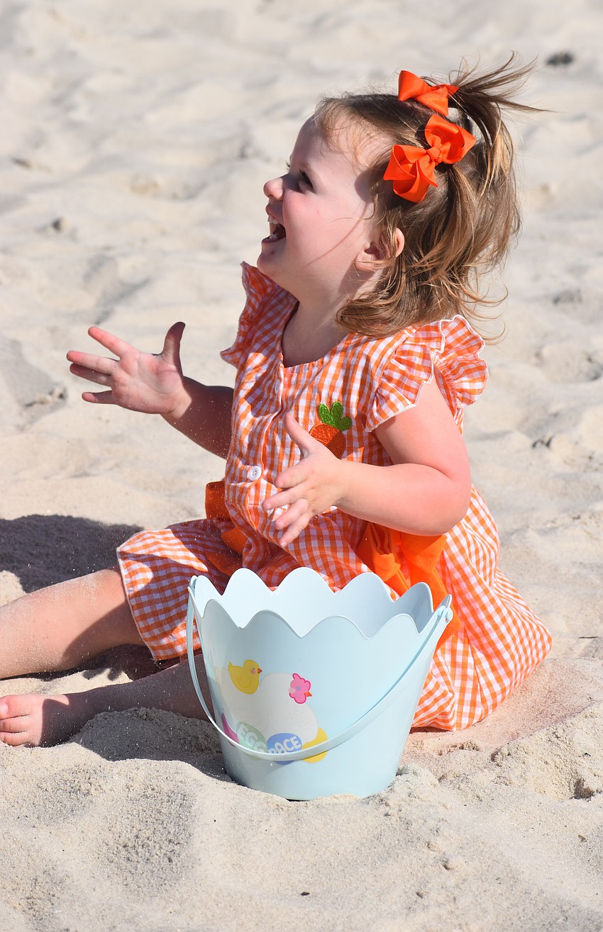 Lakewood Ranch's Bennett Puzzo, 1, fills her basket during Eggstravaganza at Waterside Park March 28.