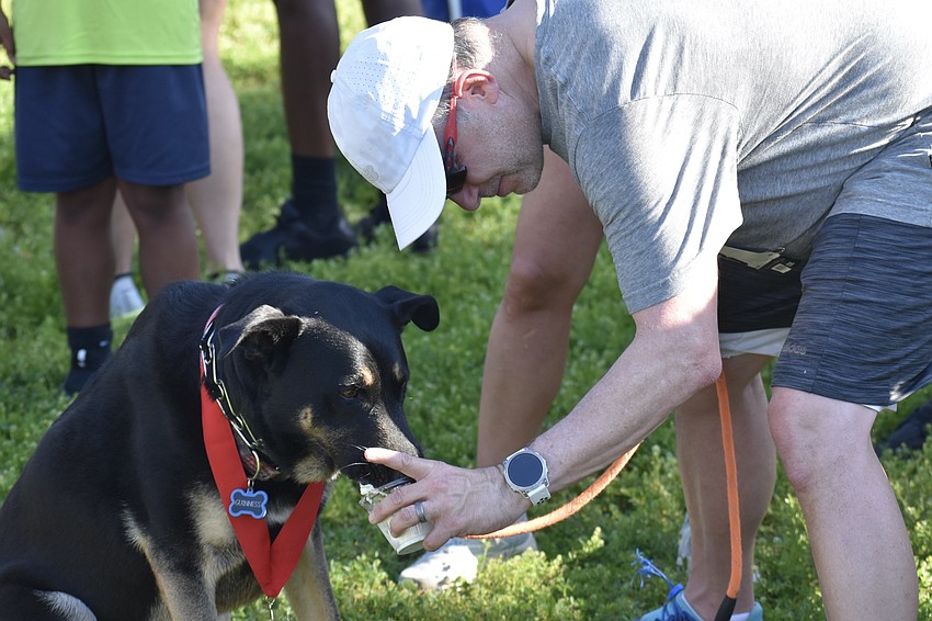 Greg Jaeger helps Guinness during the pie eating contest.