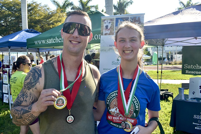 Kyle Stuart and his daughter Kadence Stuart, 16, wear their medals.