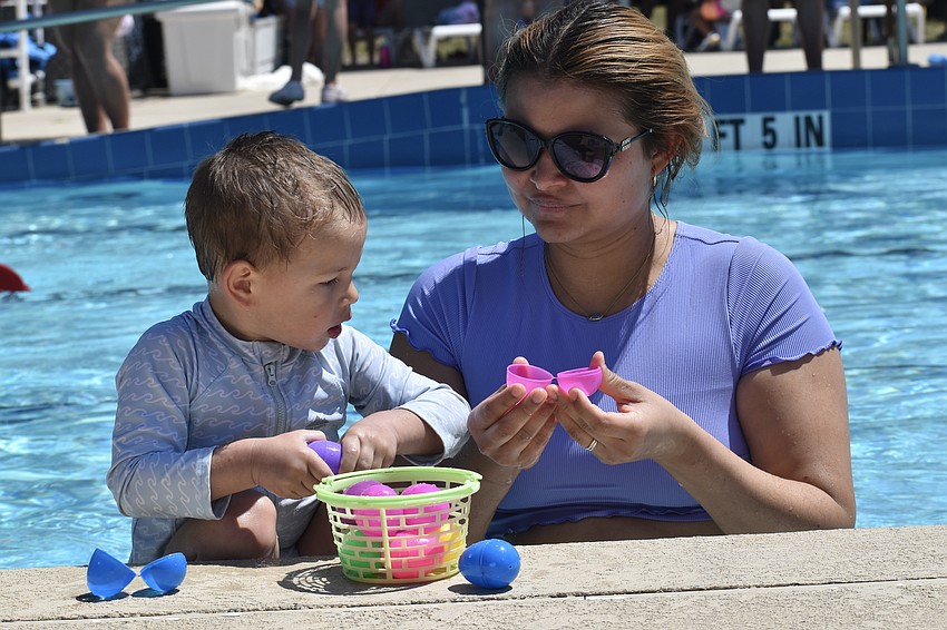 River Bowers, 2, and his mom Hassel Bowers look for prizes inside the eggs.
