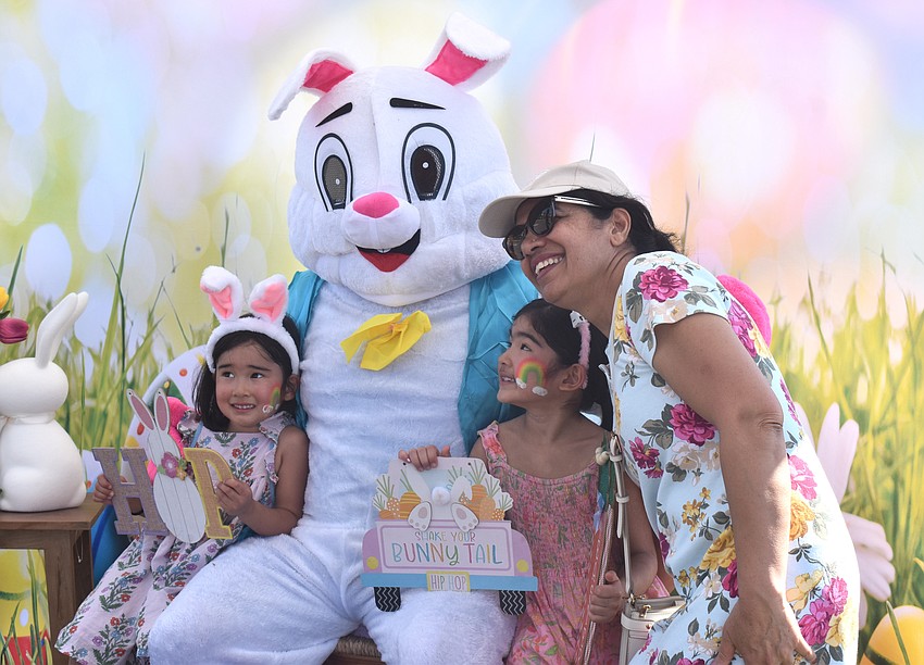 Saanvi Sarna, 4, Sloane Sarna, 7, and their grandma, Seema Sarna, pose with the Easter Bunny at Eggstravaganza March 28.