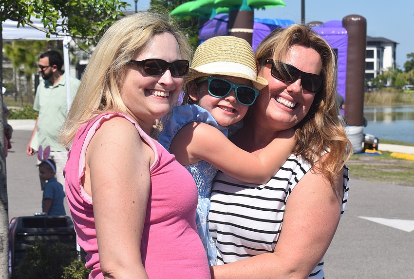Lakehouse Cove's Natalie Scholz, 5-year-old Gabi Scholz and Suzi Scholz attend Eggstravaganza at Waterside Park March 28.