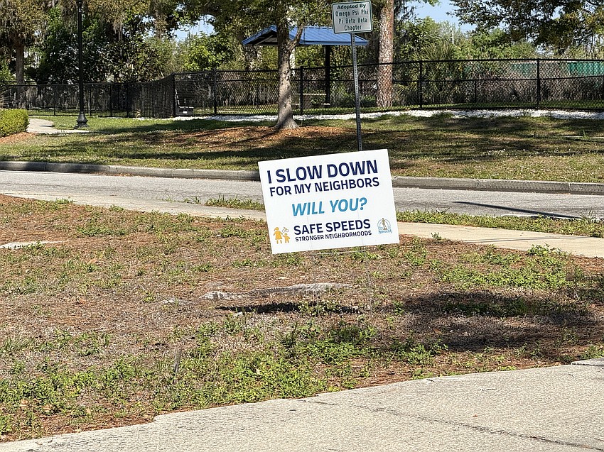 Signs in neighborhoods throughout Sarasota, such as this one in Gillespie Park, request drivers slow down.