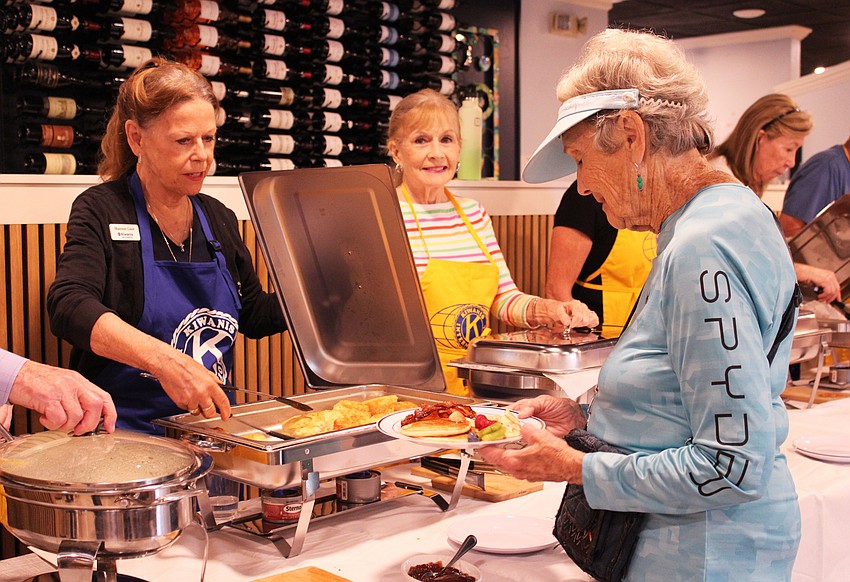 Shannon Gault dishes up biscuits at the Kiwanis Club of Longboat Key breakfast fundaiser.